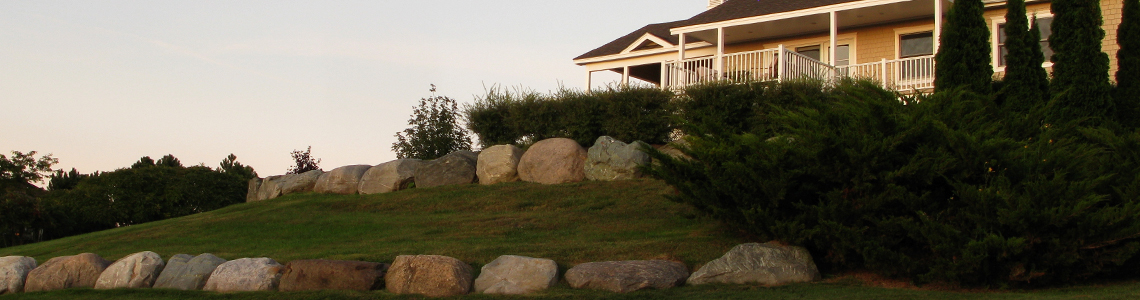 Stone wall with flowers and mulch