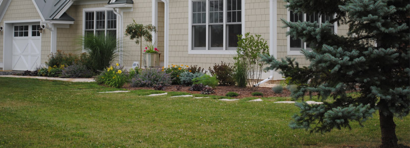 Bright green grass show off the new turf installation performed for this local Vermont residency.